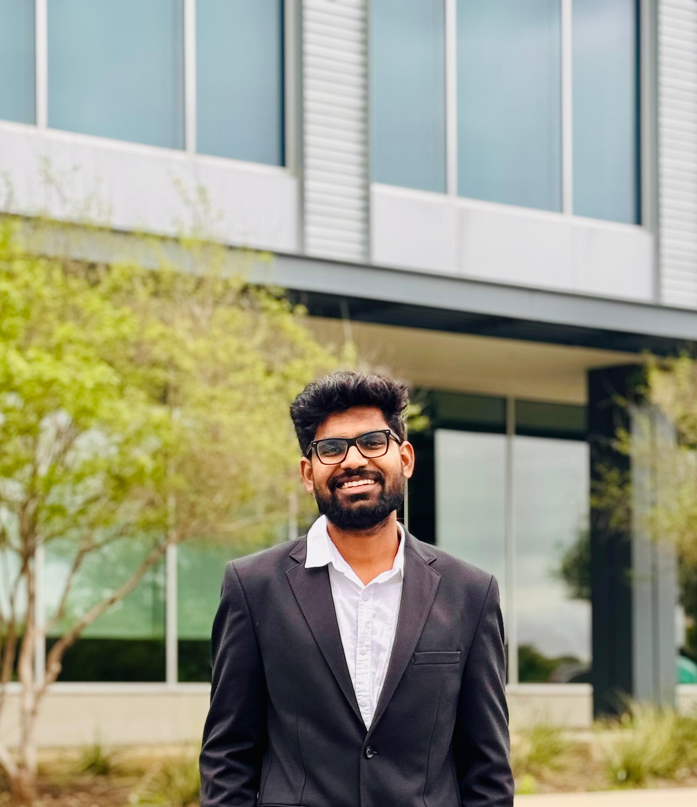 Manoj Pasunoori with UTA degree folder